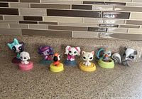 All eight LPS figures lined on countertop