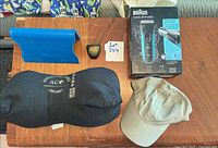 Full lot overview: shaver box, posture support, cushion, cap, pedometer