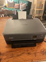 Top view of Canon Pixma TS5320 printer with rear paper feed and output tray visible