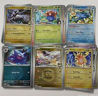 Stack of assorted Pokémon cards with six top cards visible