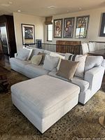 Front angled view of sectional and ottoman showing upholstery and cushions