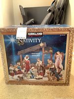 Front view of retail box showing nativity artwork and brand