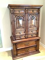 Front view of dresser closed showing carved doors and drawers