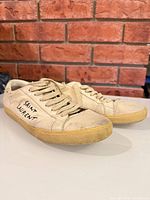 Side view showing Saint Laurent branding and distressing