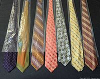 All seven Chiarini ties laid flat to show colors, patterns and individual plastic sleeves