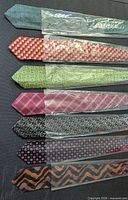 Seven neckties individually packaged showing colours and patterns