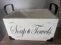 Front view showing script text, metal handles and corner brackets