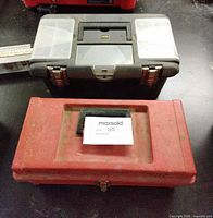 Red and grey plastic toolboxes closed