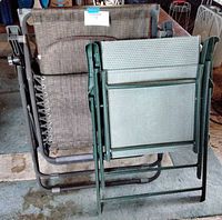 Chairs folded side by side showing frames and fabric