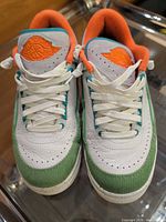 Top view of both sneakers showing toe boxes, laces, tongue logos, color scheme