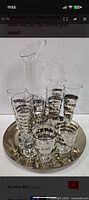 Entire set on tray showing decanter, flutes, cordials and tray