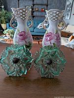 Front view of two hand-painted vases and two glass tiebacks