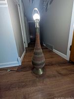 Entire lamp illuminated, showing full height, base to bulb