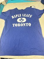 Full view of front graphic on blue Toronto Maple Leafs youth T-shirt
