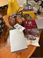 Lot overview showing metal pumpkin, Bowring box with ornaments, White Mustang figurine ashtray