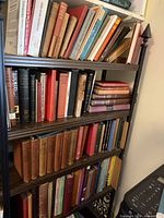 Full bookcase showing three shelves of cloth hardcovers including Great Books set