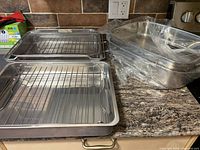 roasting pans with wire rack and mesh basket on countertop
