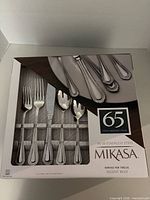 Front view of boxed Mikasa Regent Bead 65-piece flatware set