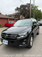 Front three-quarter view of black 2015 Volkswagen Tiguan