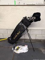 Full view of Golden Bear stand bag with clubs and accessories on floor