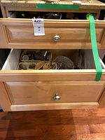 Two kitchen drawers containing assorted utensils and flatware