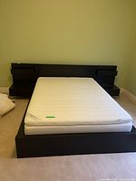 Full view of platform bed frame with mattress in place