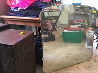 Large vintage mirror with wooden back standing upright, clear reflection