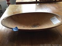 Top and side view of the oval hand carved wooden dough bowl showing interior and general shape.