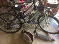 Two men's bicycles side by side: purple Roadmaster and black Legrande