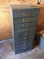 Front view of a tall gray metal file drawer cabinet with ten drawers.