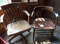 View of two wooden office chairs side by side showing full structure and design, highlighting armrests and backs.