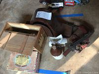 Seth Thomas clock case, wooden nutcracker, and a ceramic jug or bottle lid.