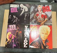 Front view of four Billy Idol vinyl record sleeves laid out