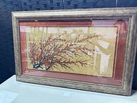 Full view of framed artwork on table