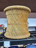Full side view of woven rattan stool