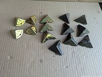 Full group of 14 brass corner protectors showing both polished and patinated styles
