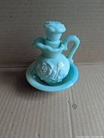 pitcher with stopper seated in basin
