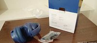 Headphones, box, cables on table