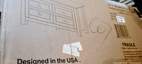 Manufacturer’s carton with line drawing of TV stand and product text