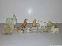 Front view of all 12 carved animal figurines