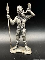 Front view of Viking figurine with horn and spear
