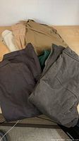 Pile of four garments showing colors and fabrics