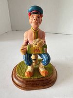 Front view showing complete figurine, McDonald’s box, numbered base visible