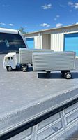 side view of cab and two box trailers joined