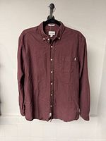 Front view of burgundy Frank And Oak button-up shirt on hanger