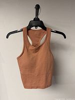 Front view of ribbed terracotta crop tank on hanger