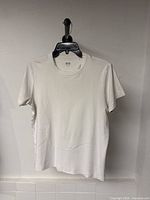 Front view of white Uniqlo U T-shirt on hanger