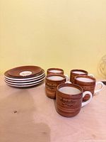 Entire set of five cups and five saucers on table