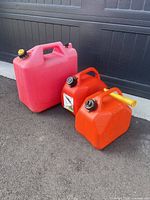 Front view of three gas cans showing sizes and caps