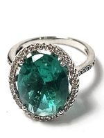 Front view of ring showing oval green stone and rhinestone halo